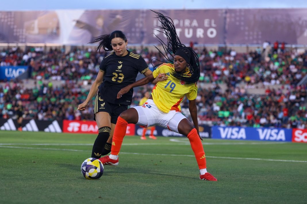 Jugadoras de México y Colombia disputando el balón.